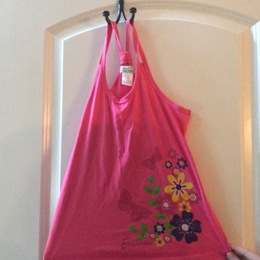 A pink tank top with flowers and butterflies